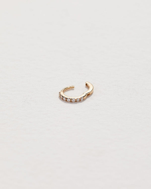 gold hoop piercing with white diamonds