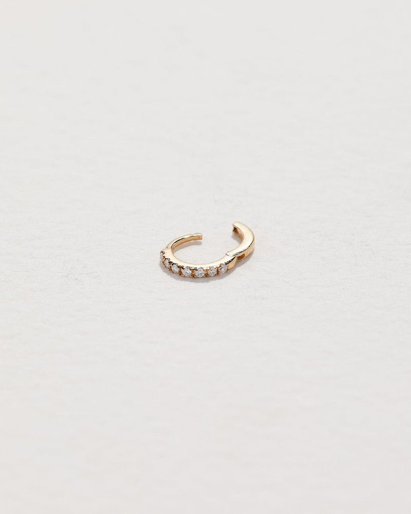 gold hoop piercing with white diamonds