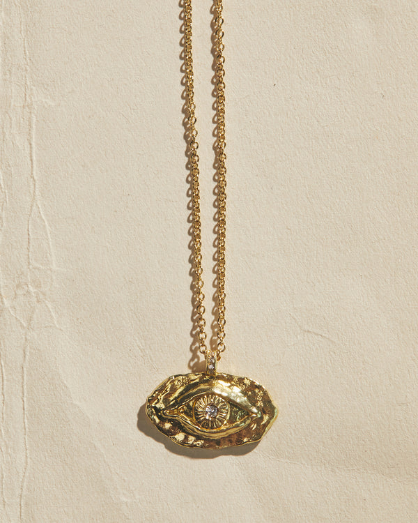 golden eye pendant necklace with white diamond