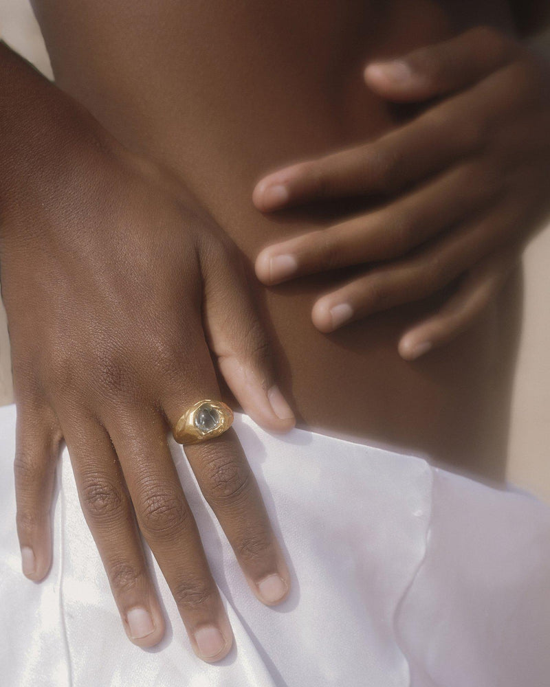 gold braided ring on the models hand