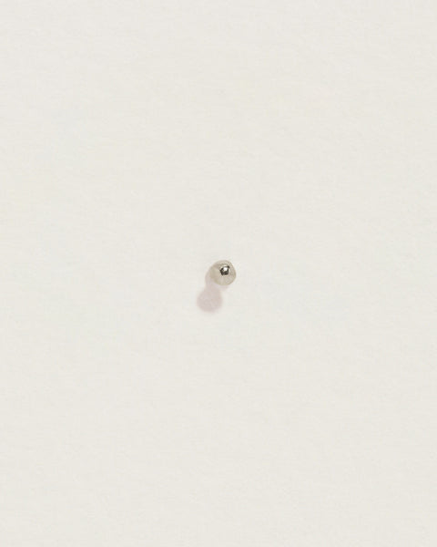 Close-up of 2mm Tiny Molten Stud showcasing its irregular molten-textured round head