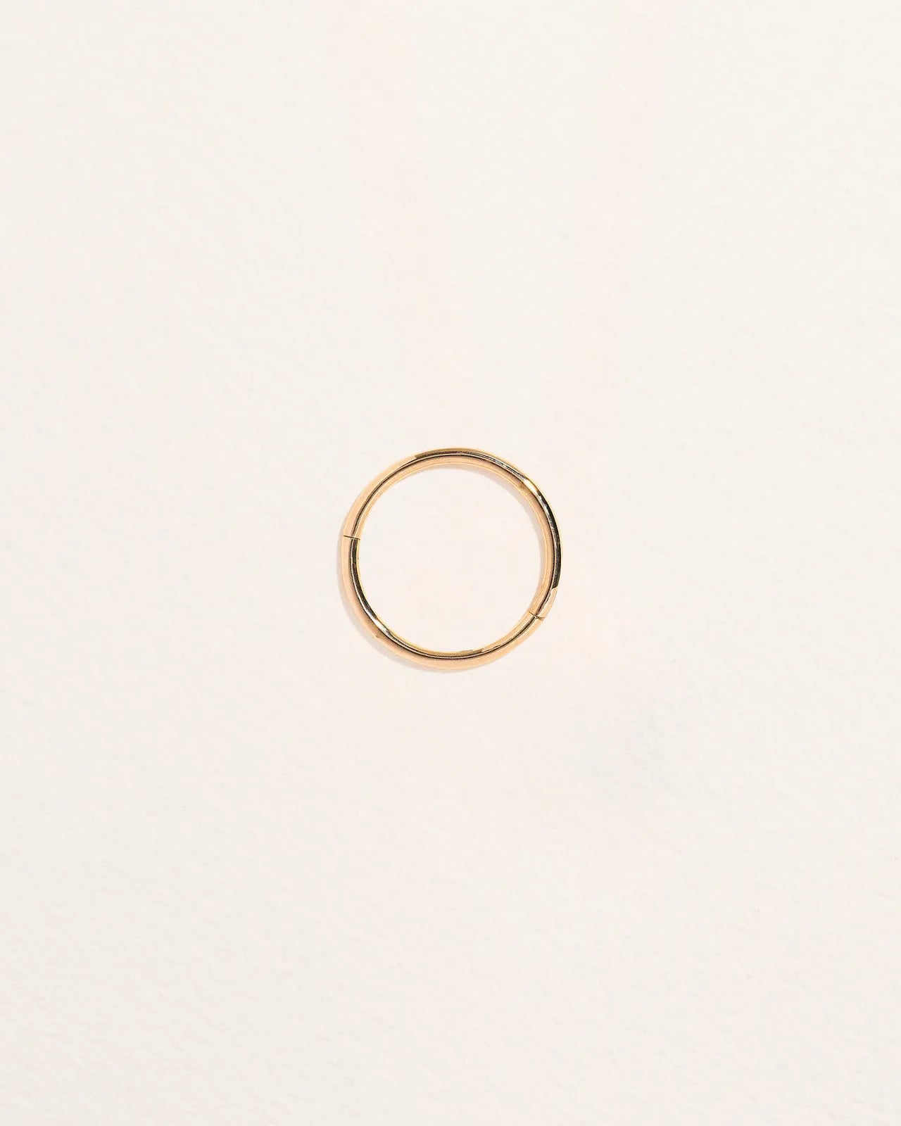14K yellow gold seamless clicker piercing hoop, 12mm inside diameter, shown flat from above