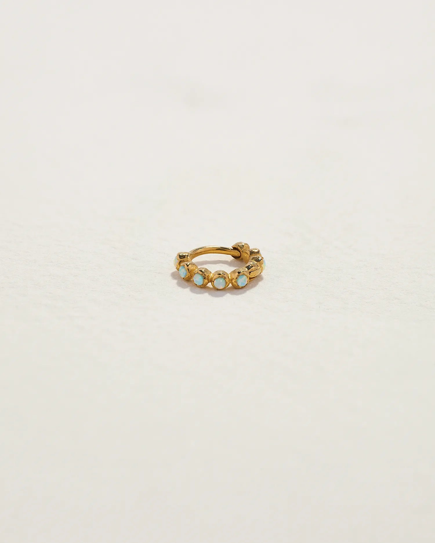 6mm Molten Eternity Huggie by Pamela Love – Piercing in #product_material# (#product_color#).  6mm-molten-eternity-huggie-opal