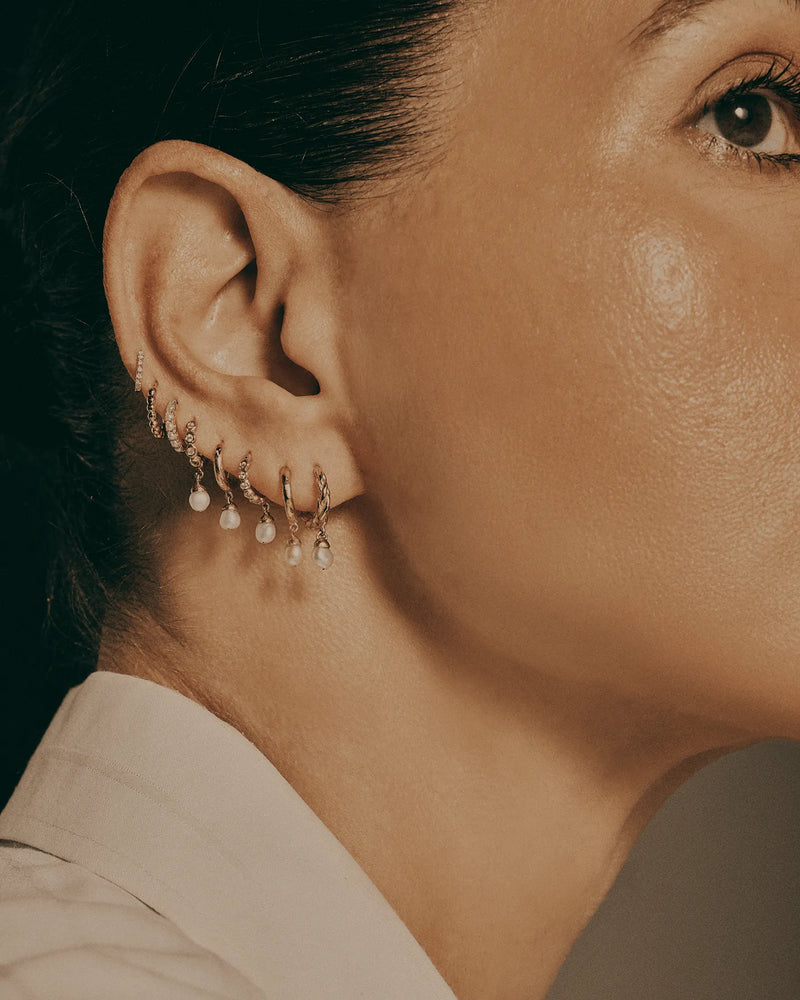 Braided Baroque Huggie by Pamela Love – Piercing in #product_material# (#product_color#). 