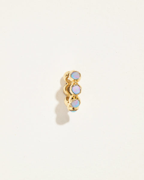 Molten Stone Huggie with three round iridescent stones, shown from the front