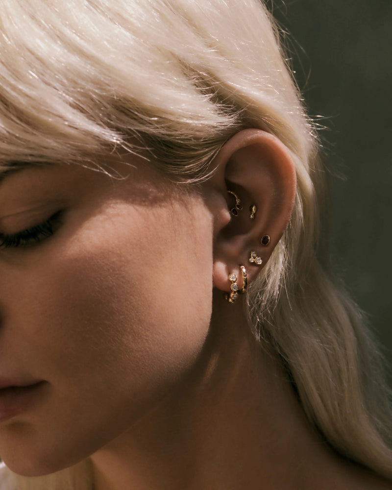 Molten Stone Huggie by Pamela Love – Piercing in #product_material# (#product_color#). 