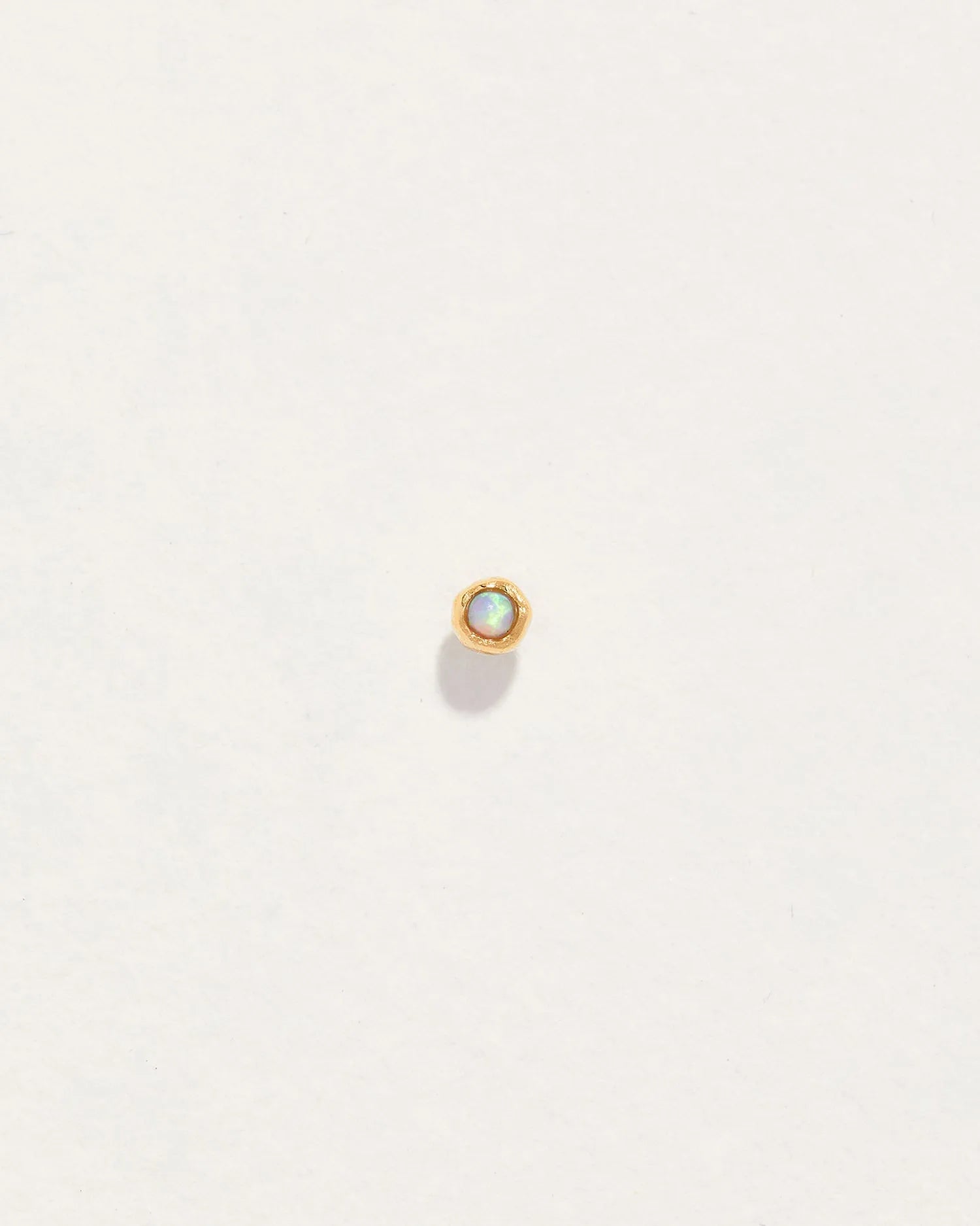 Petite Nugget Stud by Pamela Love – Piercing in #product_material# (#product_color#).  petite-opal-nugget-gold-lab-created-opal-white