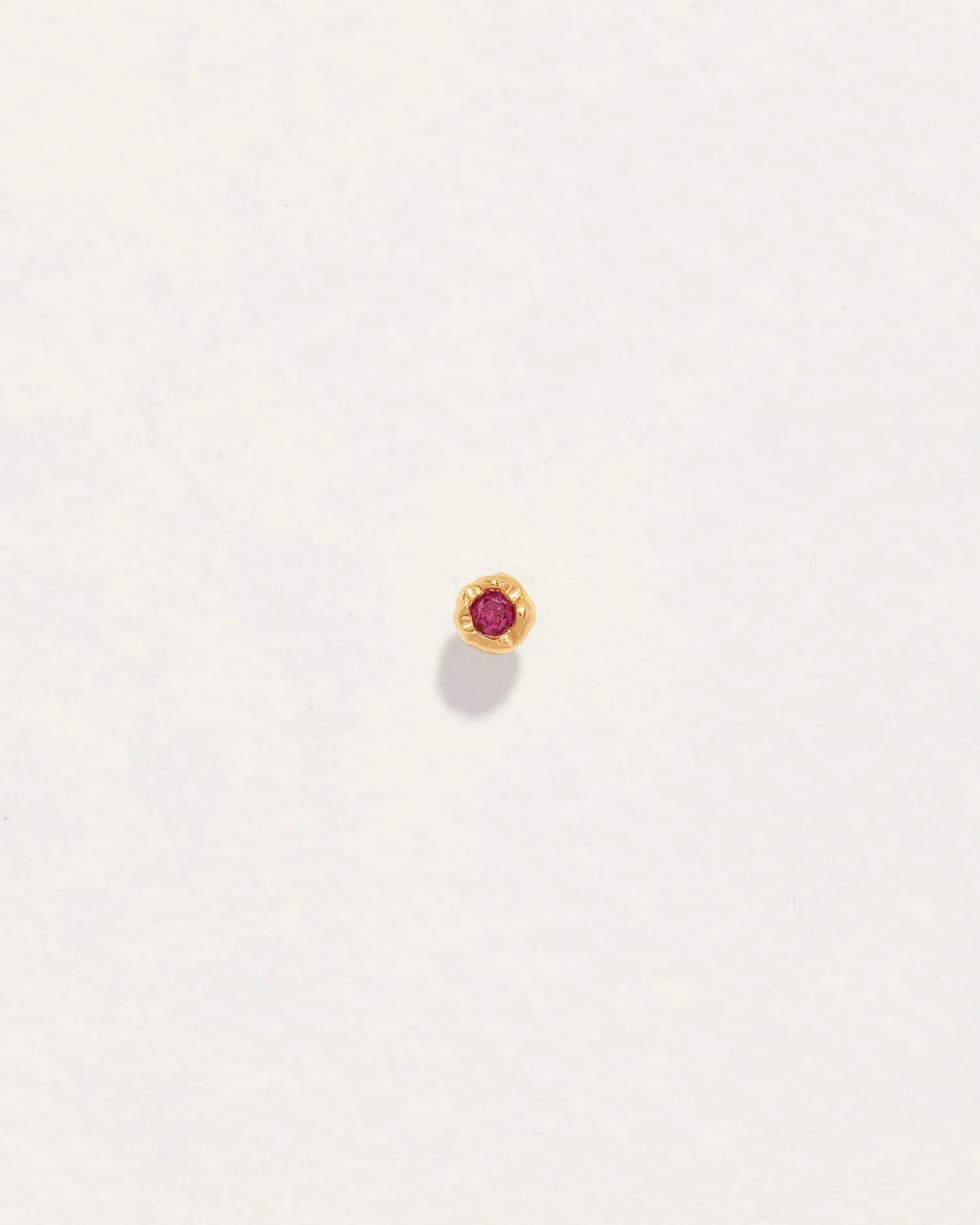 Petite Nugget Stud by Pamela Love – Piercing in #product_material# (#product_color#).  petite-ruby-nugget-gold-ruby-red