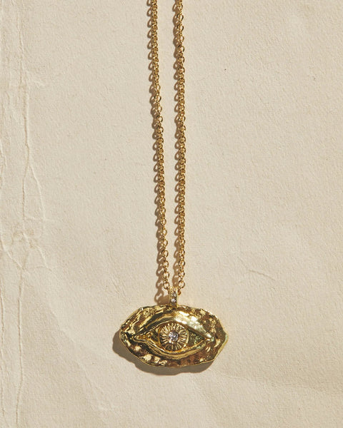 18K yellow gold pendant necklace with eye motif and central diamond iris, front view on chain