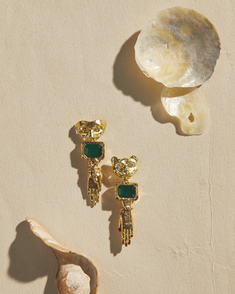 gold mask and hand earrings with emerald