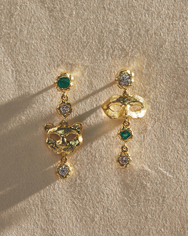 gold mismatched mask earrings with emerald and diamond