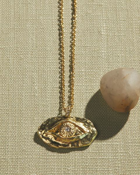 gold eye pendant with diamond