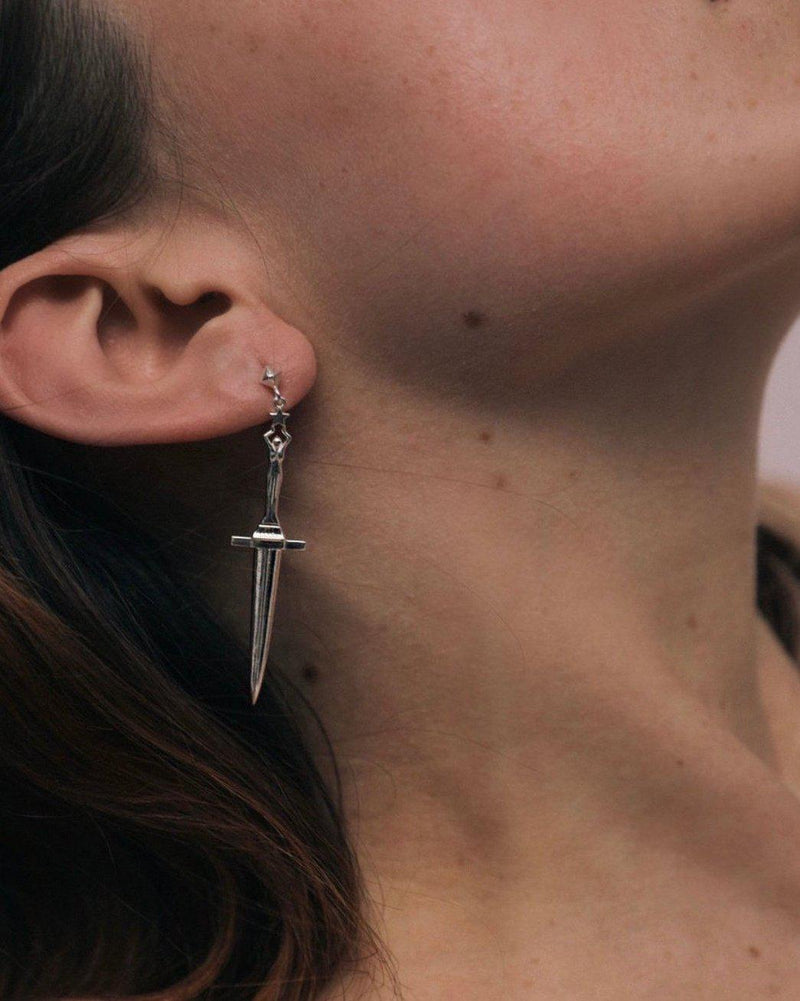 silver dagger earring on the model