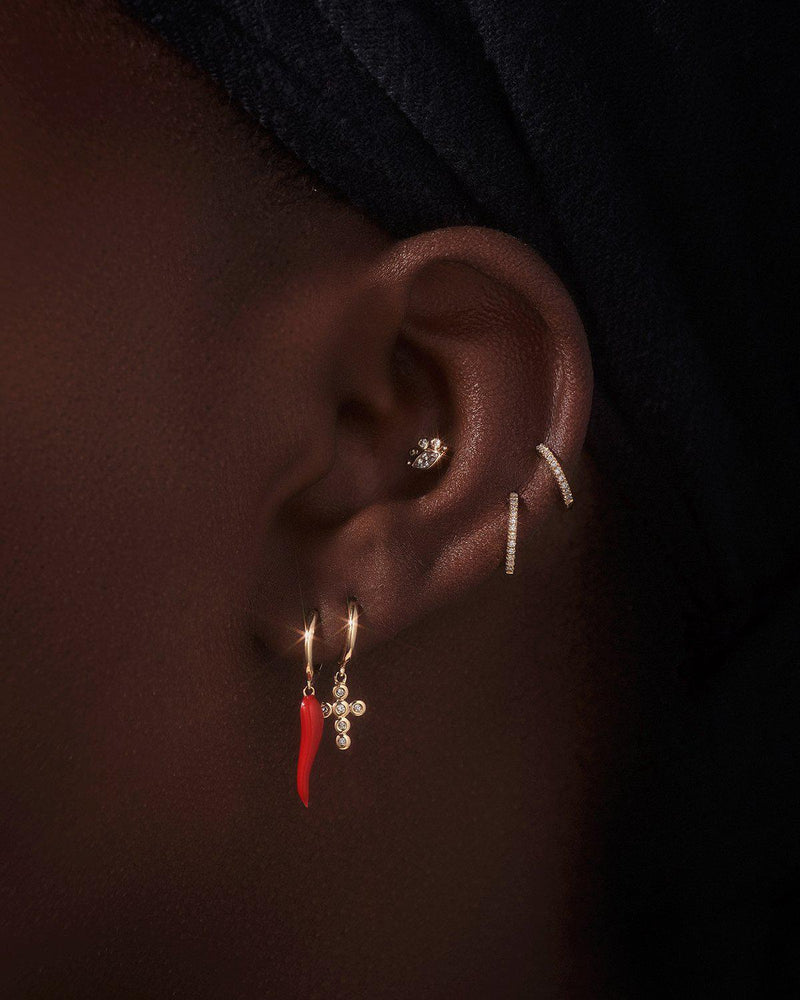 diamond cross huggie earring on the model