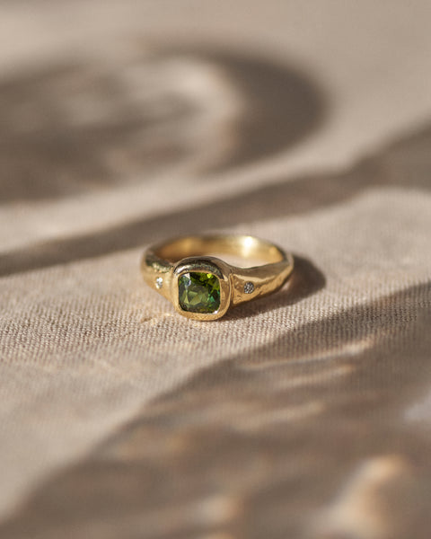 gold band ring with green tourmaline stone