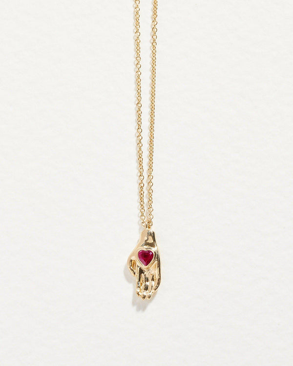 heart in hand pendant with ruby