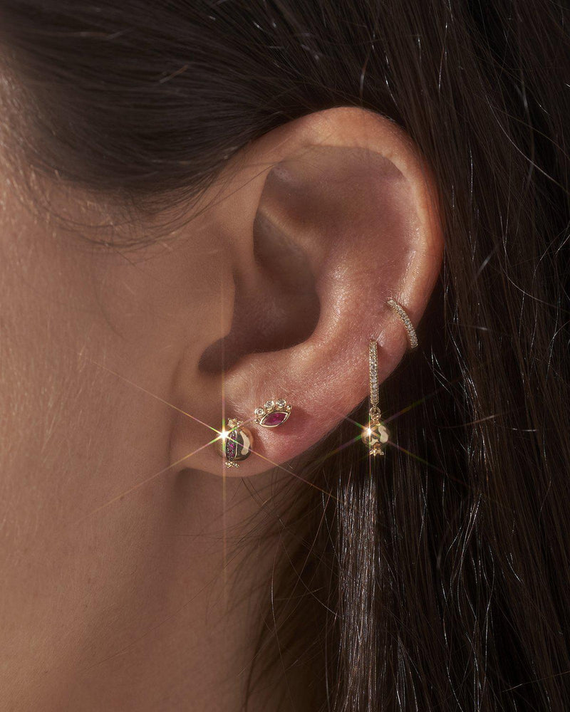 gold pomegranate stud earring on the model