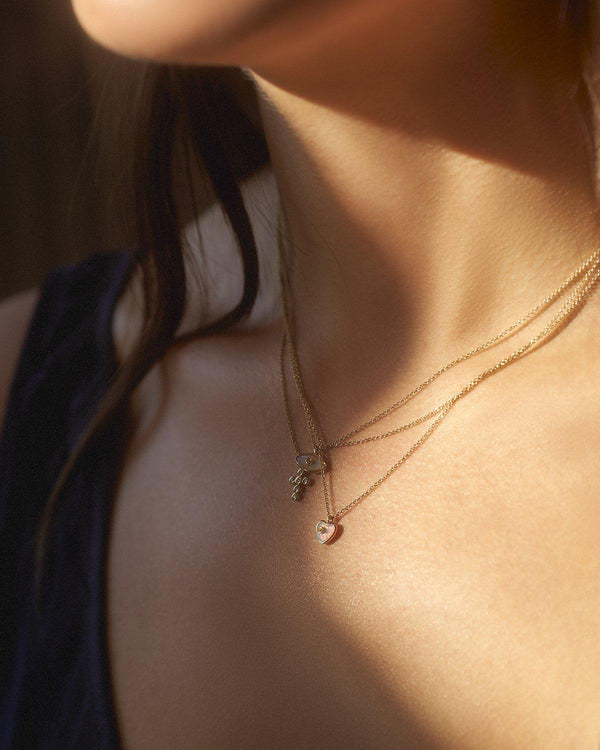 mini gold heart necklace on the model
