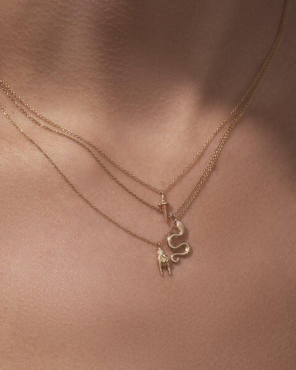 gold pendant necklaces on the model