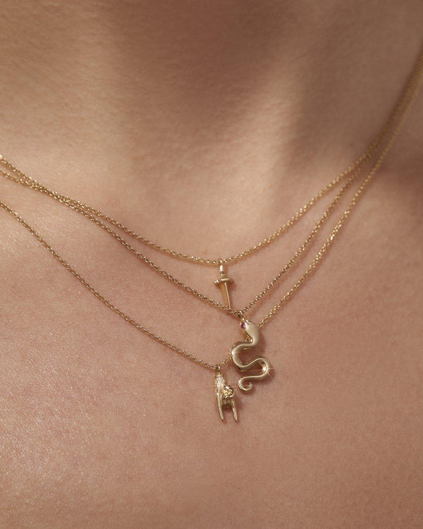 gold mano cornuto pendant on the model