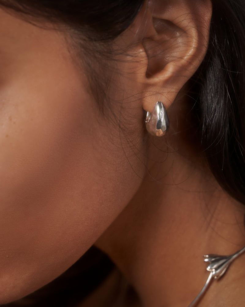 hammered hoop earrings on models ear