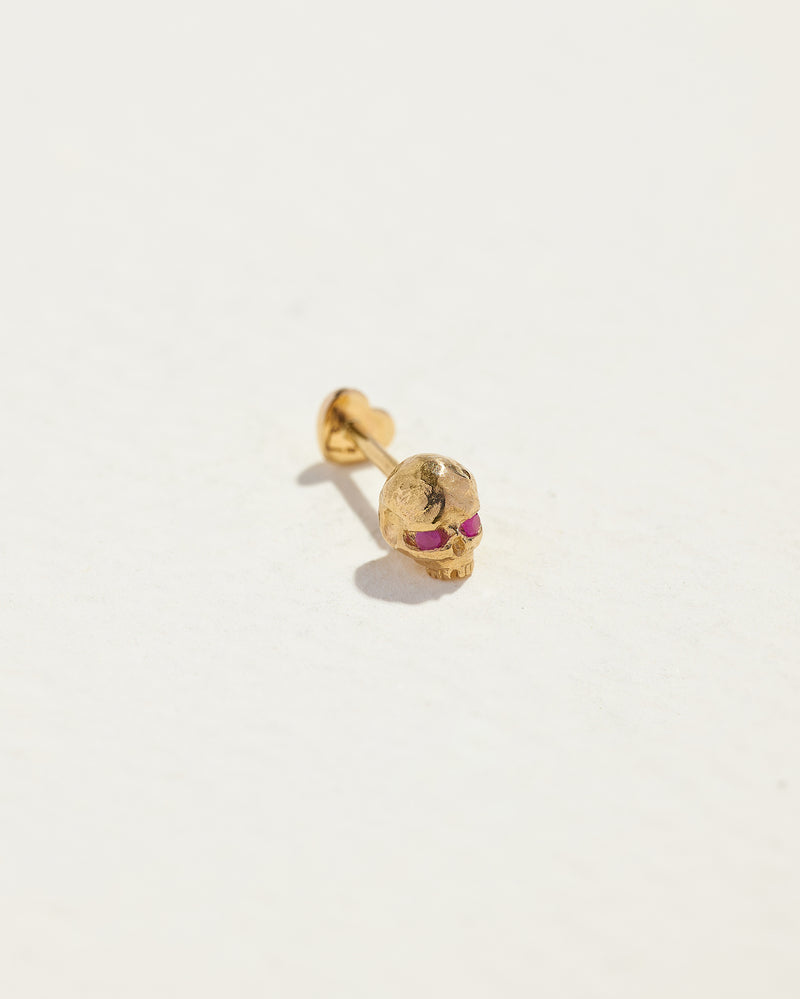 gold skull stud earring with ruby eyes