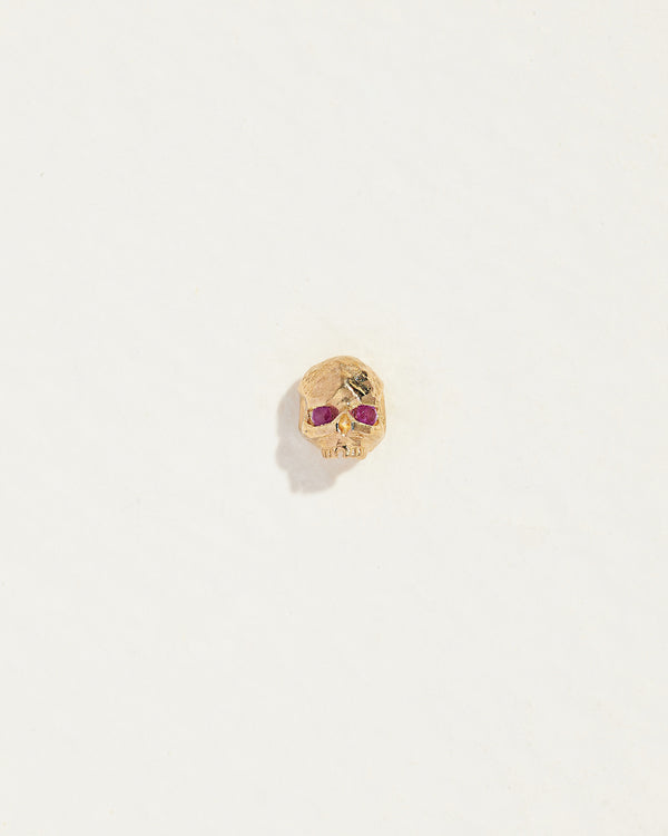 gold skull stud earring with ruby eyes