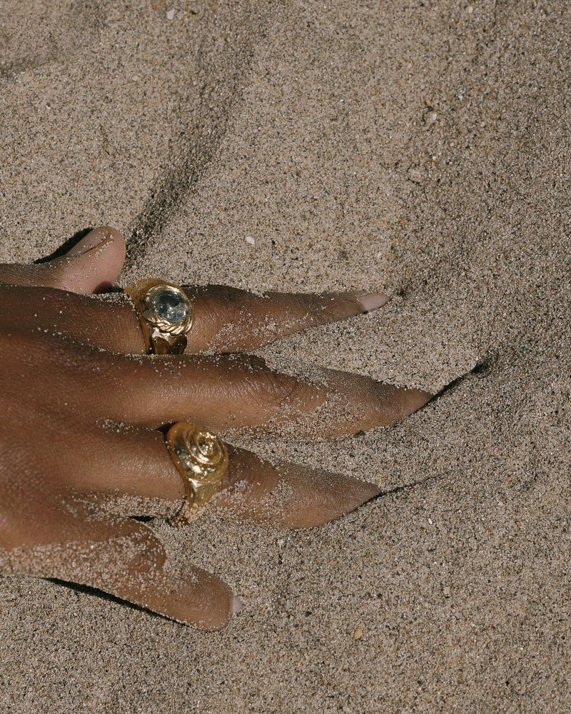 braided gold ring on the models hand