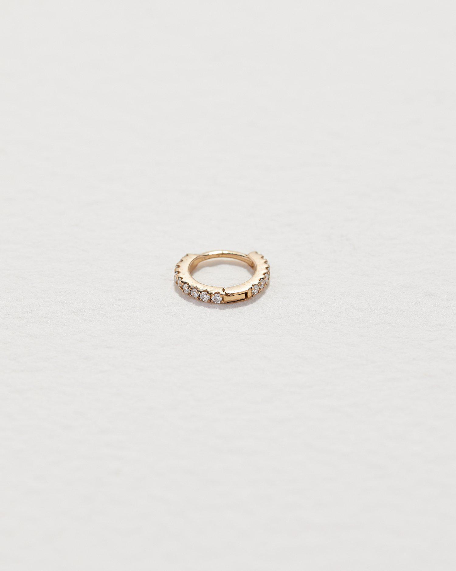 Tiny Full Pavé Huggie by Pamela Love – Piercing in #product_material# (#product_color#). tiny-full-pave-huggie-gold-diamond-white-1