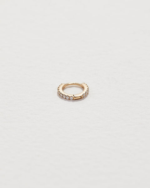 Tiny Full Pavé Huggie by Pamela Love – Piercing in #product_material# (#product_color#). tiny-full-pave-huggie-gold-diamond-white-1