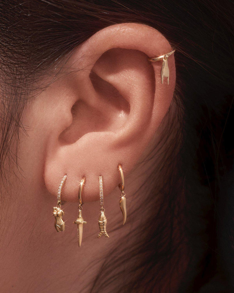 pamela love gold huggie earrings on the model