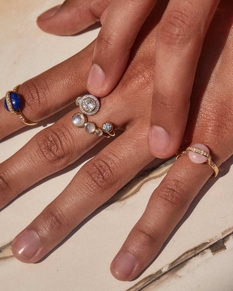 pink opal saturn ring on the models hand